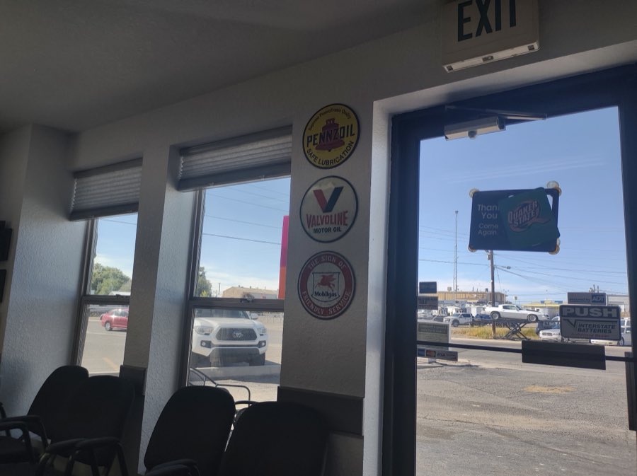 Finch Lube & Car Care's waiting area with vintage Pennzoil, Valvoline and Mobilgas motor-oil signs.